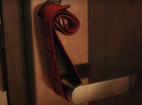 red deadbolt locking strap on a doorknob